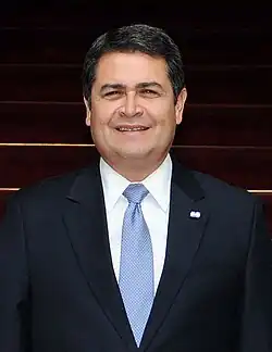 Hernández looking to the side in a suit