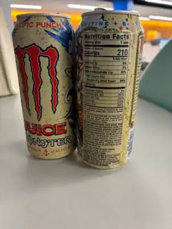 Two cans of Juice Monster (Pacific Punch flavor), one of them showing off the nutrition facts label.