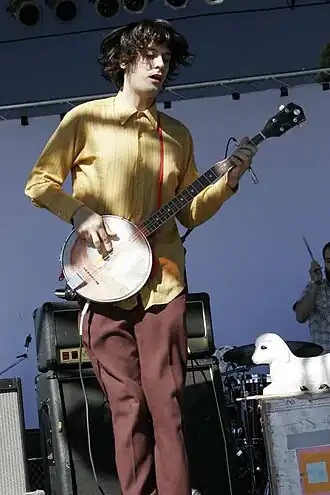 Koster playing the banjo at ArthurFest 2005 (signature lamb-lamp seen in background)