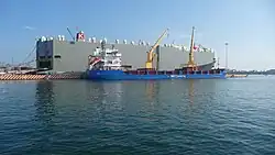 Photograph of ships, the large one says BBC Chartering