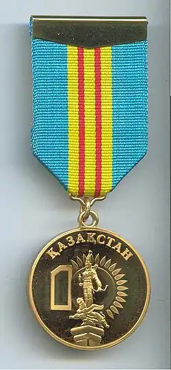 The image of the upper part of the monument on the jubilee medal in honor of the 10th anniversary of independence of the Republic of Kazakhstan