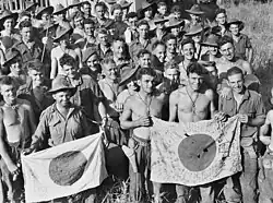 Soldiers of the Australian Army's 2/6th Independent Company display Good Luck Flags they captured during the Battle of Kaiapit on 26 September 1943.