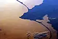From an astronaut's perspective in low-Earth orbit, land surfaces usually appear brighter than water. But in this image, sunglint inverts this pattern: The dark blue areas are land (Kaliningrad).