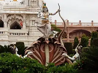Statue outside temple depicting Kaliya conquered by Krishna