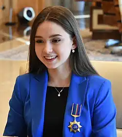 Kamila Valiyeva wearing a blue jacket and medal