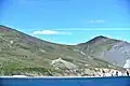 Cape Dezhnev (Chukotka, Russia) with lighthouse (Dezhnew Monument) and abandoned village Naukan
