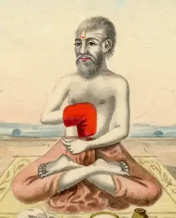 Painting of a bearded man sitting in the lotus position