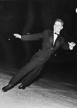 Divín skates in a suit similar to a tuxedo