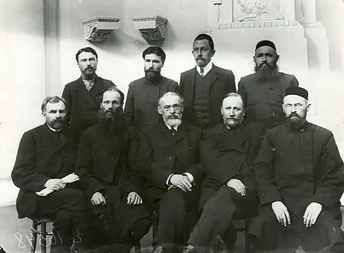 Formal photo of nine men