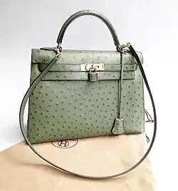 Hermès Kelly bag made of ostrich leather in a light green color, displayed upright