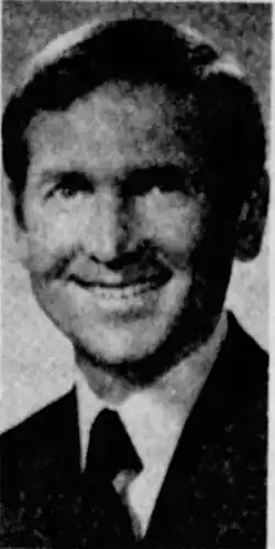 A black-and-white photo of Ken Selby in a suit