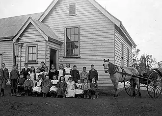 Pupils and their teacher in front of the Kewell State School in 1902