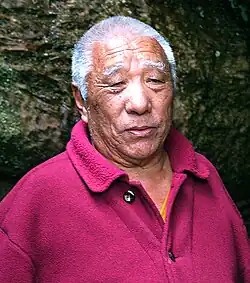 Tibetan Buddhist teacher Khenpo Tsültrim Gyamtso Rinpoche wearing a red robe.