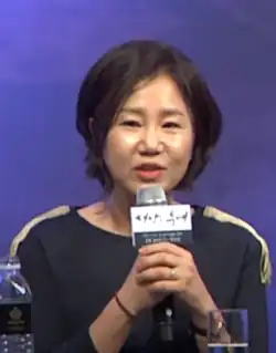Kim Eun-sook speaks into a microphone while seated at a press event in 2016.