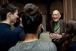 T. M. Scanlon is talking to other students at the Edmond J. Safra Center for Ethics.