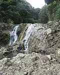 The upper swimming hole is just out of view above this small white water fall.