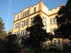 A secondary school behind trees