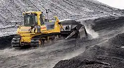 Bulldozer pushing coal in Ljubljana Power Station, Slovenia