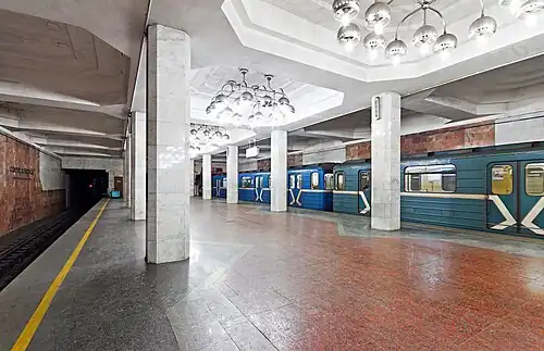 Underground station with brown floor and walls and white ceiling and columns