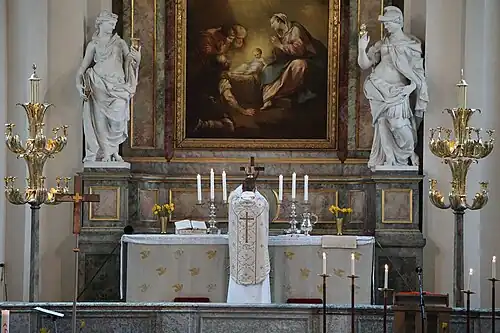 Lutheran priest elevating the chalice during the Mass at Maria Magdalena Church, Sweden