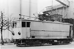 Oslo Sporveier. Tram motor vehicle type K no. 354, the "grain tram" in the unloading track at Bjølsen Valsemølle. Headlights with glare.