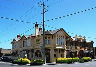 Koroit Hotel. The signpost at the right of the picture gives distances to towns in Ireland.