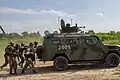 NGU soldiers training behind a KrAZ Cougar armored vehicle