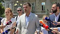 Savo Manojlović and associates holding a press conference in front of the City Assembly of Belgrade