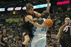 Philadelphia forward Kyle Korver attempts to get past Denver forward Reggie Evans while playing the Philadelphia Sixers at the Pepsi Center.