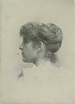 19th-century B&W portrait photo of a woman with her hair in an up-do, wearing a pale, fitted blouse.