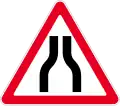 Road narrows on both sides