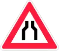 Road narrows on both sides