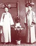 Two ladies of Qing Chinese Imperial Court wearing longhua with Qizhuang, pre-1911.