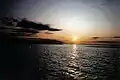 Sunset over the island looking towards the Isle of Arran. The Half tide rock is visible to the right hand side.