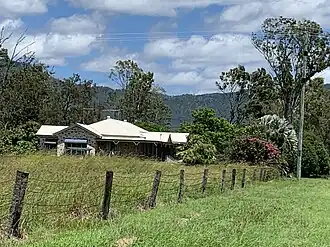 Farm with mountain range in the background, 2022