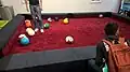Novelty football billiard table, using footballs colored to resemble pool balls.