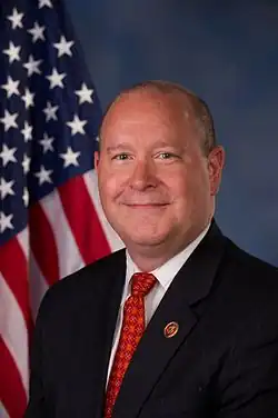 Bucshon smiling, wearing a suit