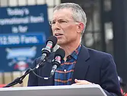 Paul J. Dolan speaking at a lectern