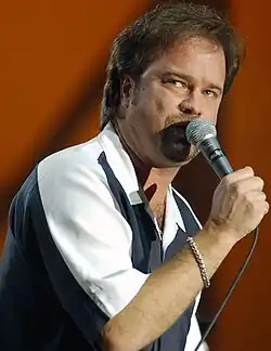 Restless Heart lead singer Larry Stewart, singing into a microphone