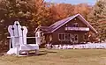 Ornate 15 feet (4.6&nbsp;m) chair as tourist attraction, maintained with a 1 imperial gallon (4.5&nbsp;L) of both primer and paint annually. North of Cloyne, Ontario, Canada