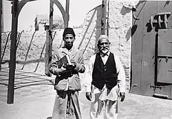 The synagogue's rabbi, photographed with his son, c. 1951