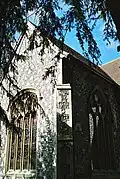 The corner of the south transept, showing the perpendicular south window contrasted with the earlier decorated east window