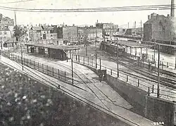Overhead view of a surface streetcar terminal with wooden canopies in an urban square