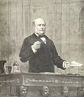 Drawing showing a man speaking at the rostrum, holding glasses in his right hand and a letter in his left.