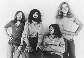 A photoshoot of the band Led Zeppelin in front of a white wall