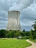 Cooling tower with old rail carriage in foreground