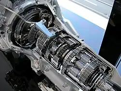 Cutaway car transmission, with exposed gears and internal machinery.