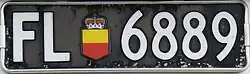 Liechtenstein license plate in the then-standard long format of 380 × 110 mm, with the gold and red escutcheon of the Princely Coat of Arms as a sticker. These plates were issued between 1961 and 1972.