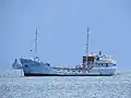 Lissa Solklint in Mangles Bay with HMAS&nbsp;Ballarat in the background, October 2021.