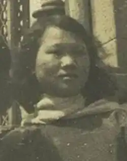 A black and white photo of a young woman facing off and to the right